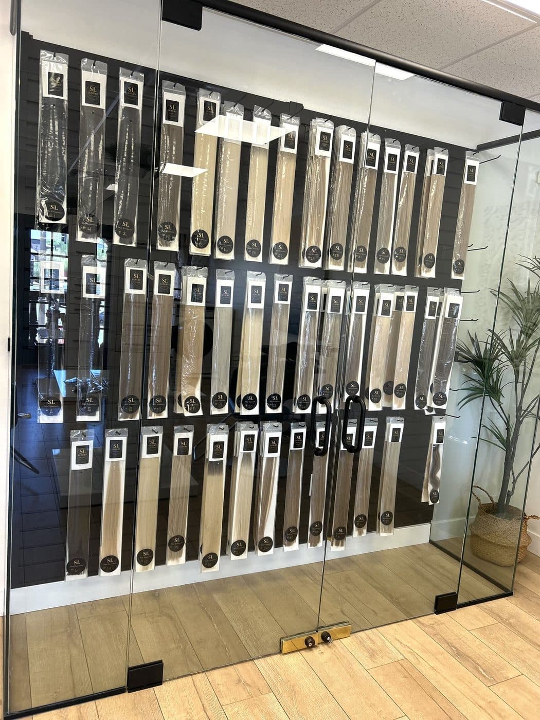 The Signature Hair inventory wall — every weft in stock at the salon